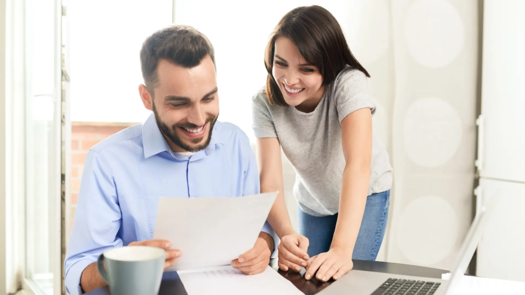 Two people sitting at a table looking at paperwork