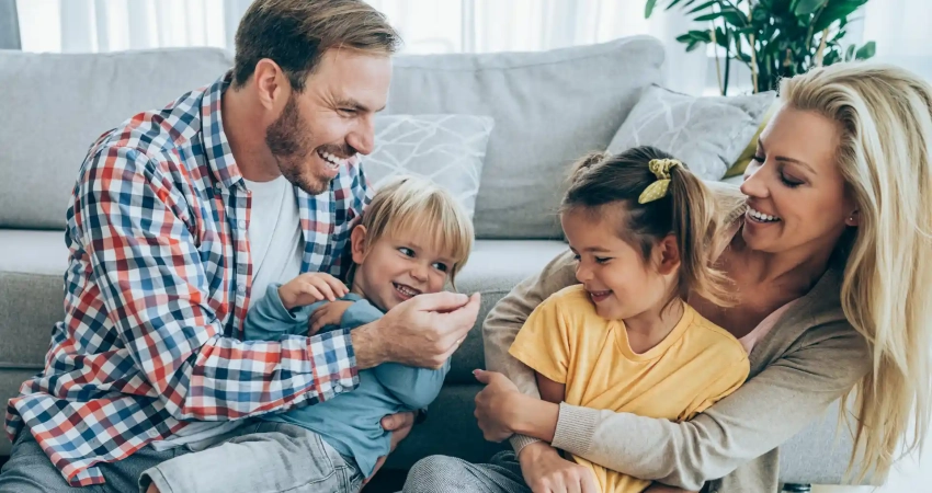 a happy family in a living room of a new home