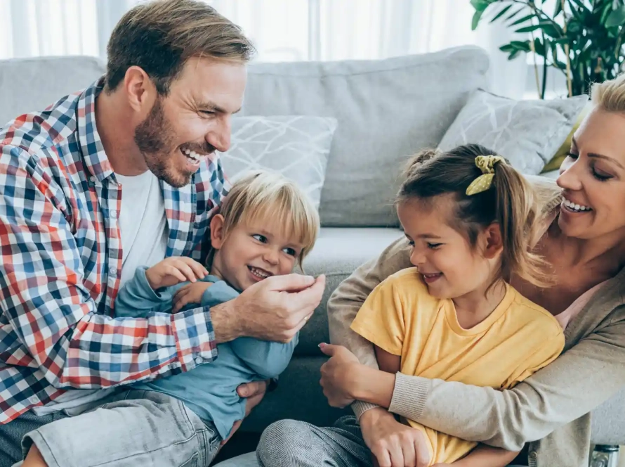 a happy family in a living room of a new home